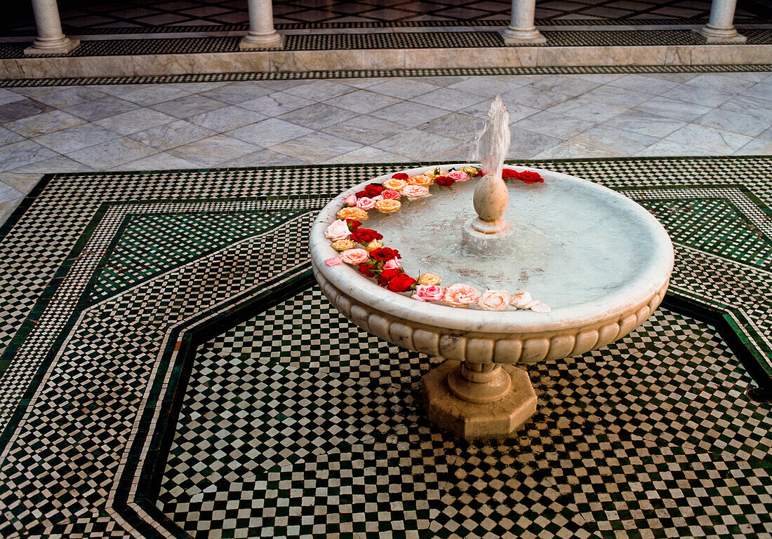 Fountain with flowers in courtyard, Marrakesh, Morocco