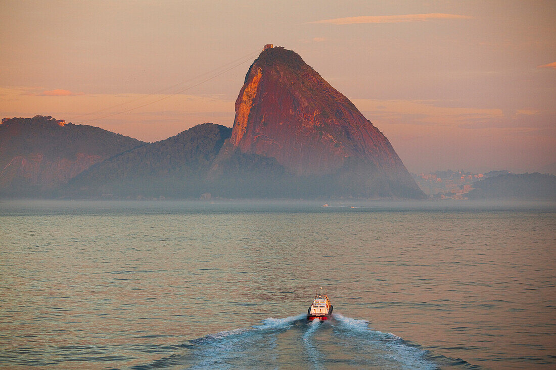 Ein Lotsenboot und der Zuckerhut bei Sonnenaufgang, Rio de Janeiro, Rio de Janeiro, Brasilien, Südamerika