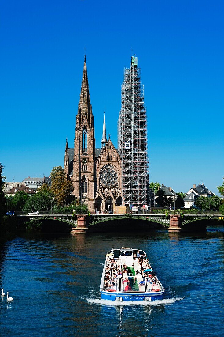 Batorama tour boat on Ill river and St Paul protestant church with scaffolding, Strasbourg, Alsace, France