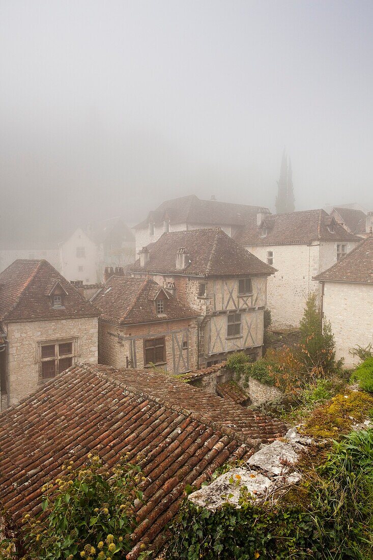 France, Midi-Pyrenees Region, Lot Department, St-Cirq-Lapopie, town overview in fog