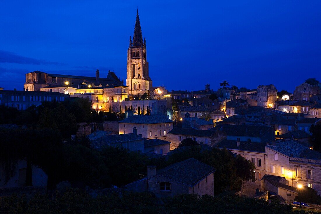 France, Aquitaine Region, Gironde Department, St-Emilion, wine town, town overview with Eglise Monolithe church, dusk