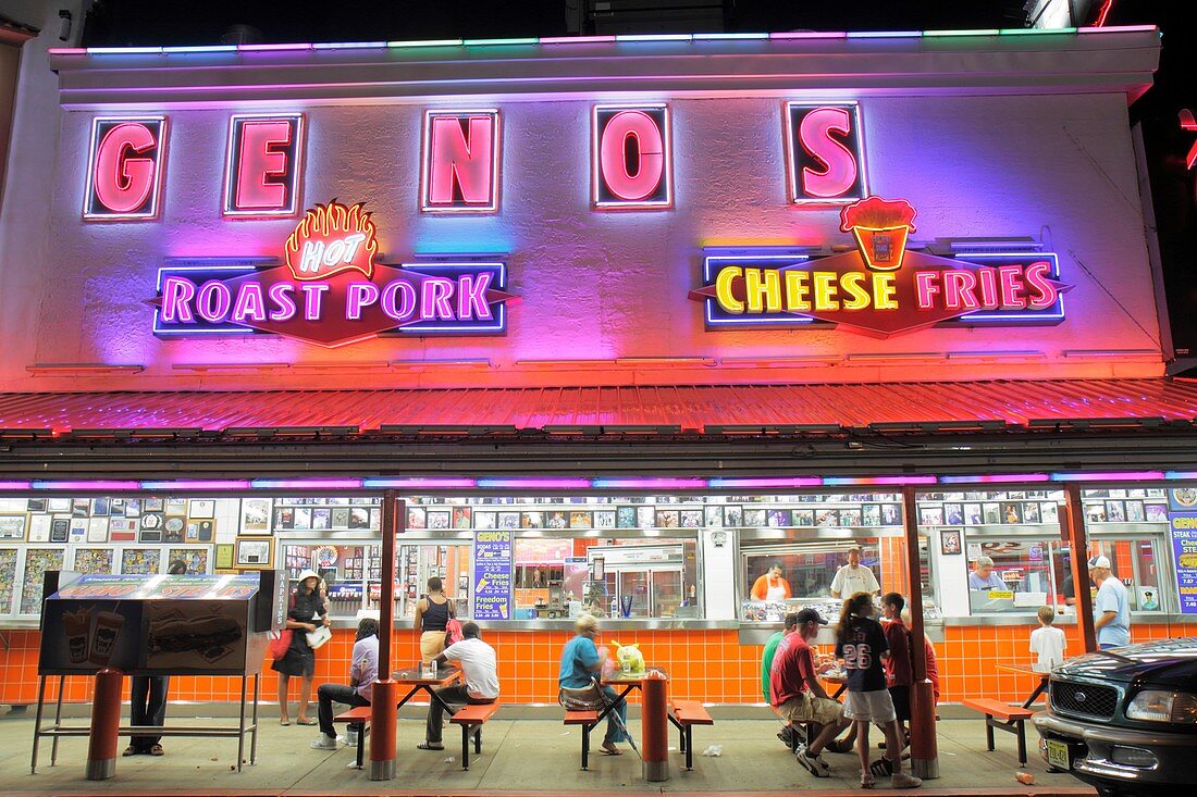 Pennsylvania, Philadelphia, South Philly, South 9th Street, Geno´s, restaurant, sandwich shop, business, landmark, cheesesteak, feud, patron, customer, sign, neon lights, marketing, man, woman, boy, girl, family, roast pork, fries, night, nightlife