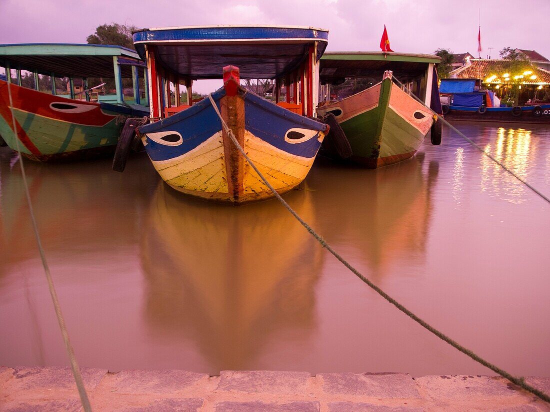 Boats in port in historic center of Hoi An, Vietnam