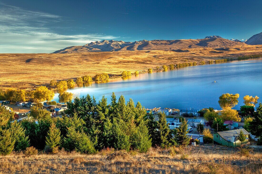 Lake Alexandrina Wildlife Refuge and fishing baches at dawn, popular spot for trout fishermen and their row boats  no engines allowed on lake, autumn, near Lake Tekapo, Mackenzie country, Canterbury