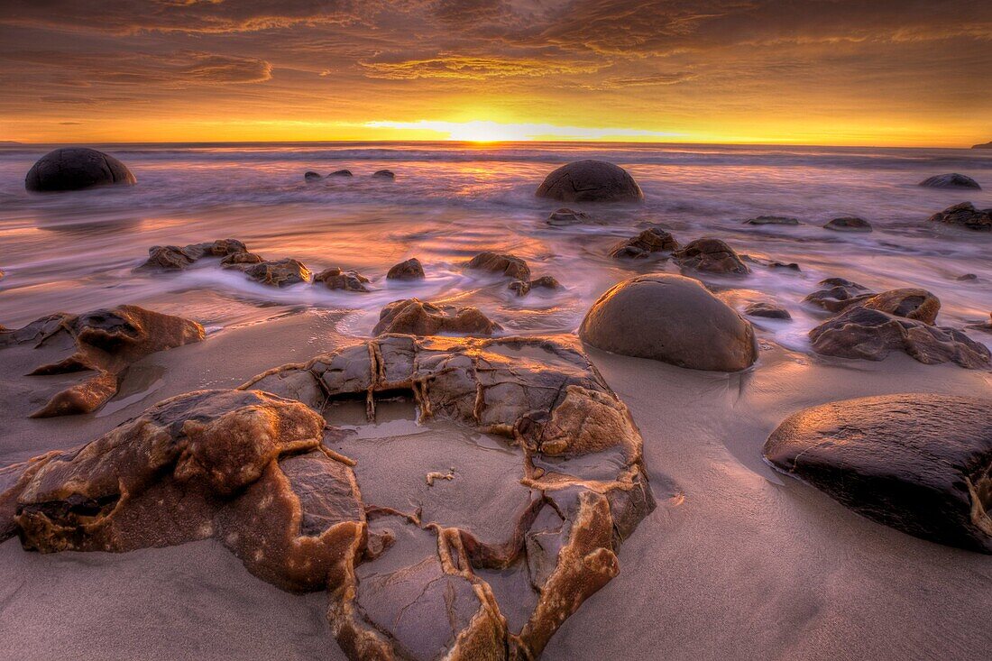 Moeraki boulders at dawn as SW front passes overhead, near Oamaru, Otago