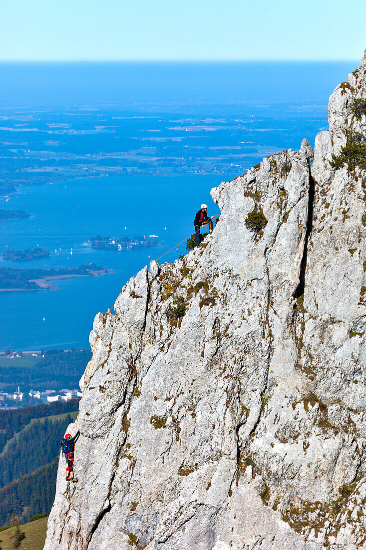 Mountaineers at Staffelstein, Kampenwand, lake Chiemsee in background, Chiemgau, Upper Bavaria, Germany