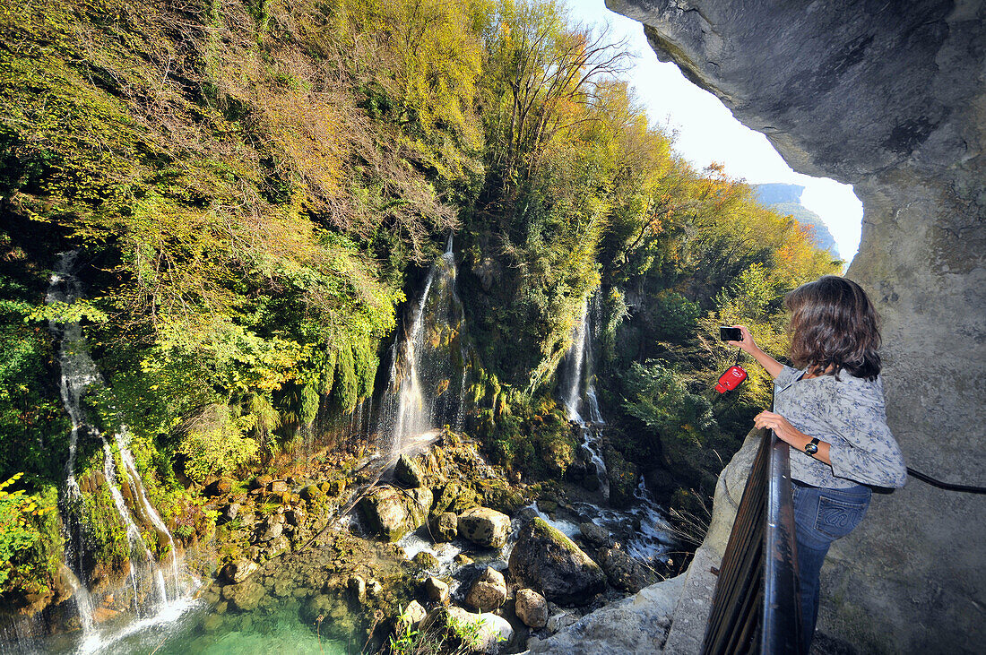 Woman taking photo of waterfalls, Cascades at Gorges du Loup, Cote d'Azur, South France, Europe