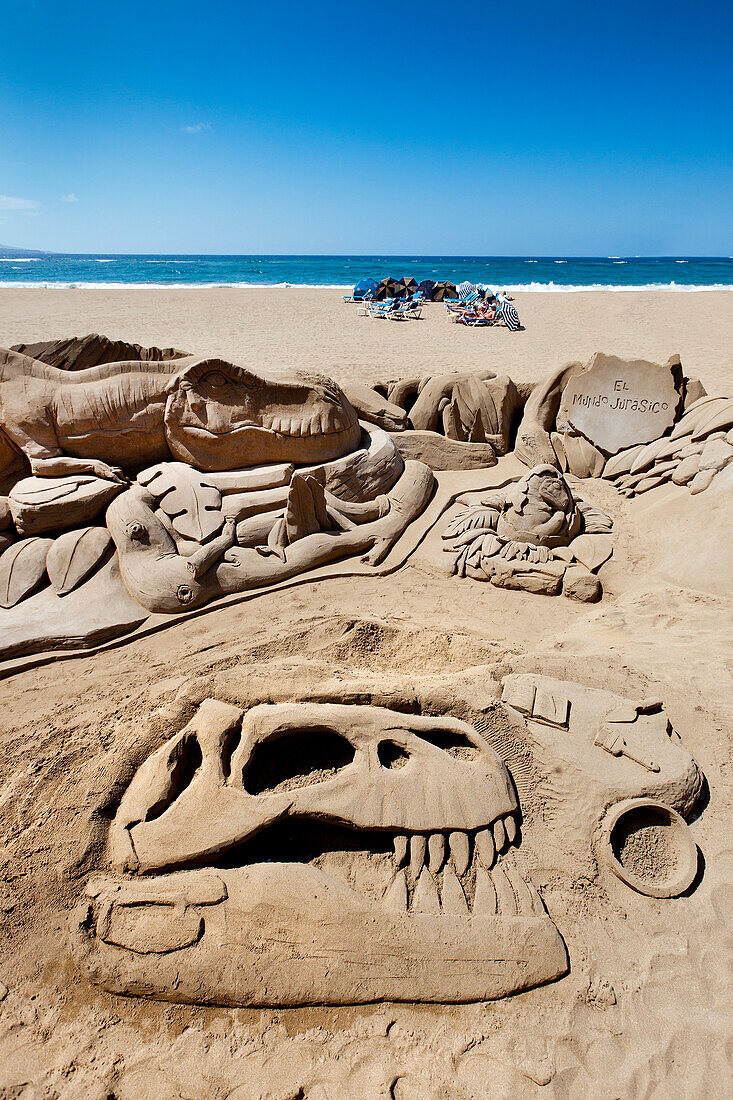 Dinosaur sand sculpture in the sunlight, Playa de Las Canteras, Las Palmas, Gran Canaria, Canary Islands, Spain, Europe