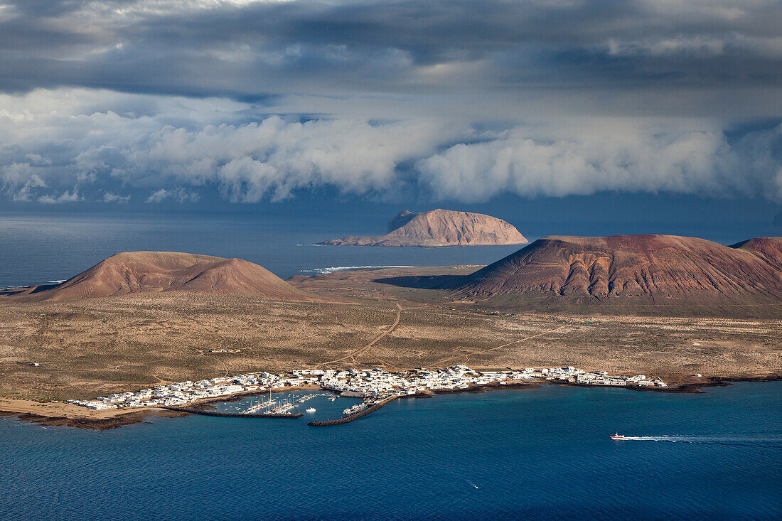 View of the island of La Graciosa under clouded sky, Lanzarote, Canary Islands, Spain, Europe