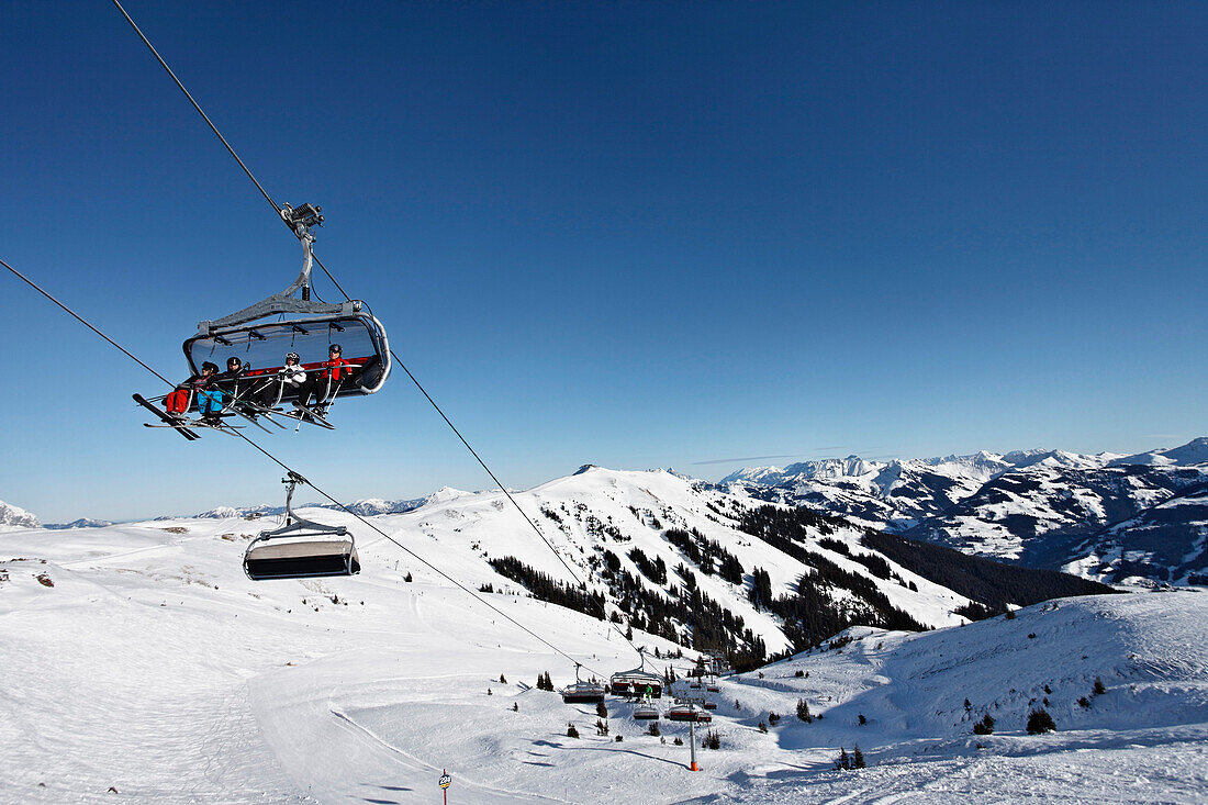 Skier in the chair lift, Ski Resort Pengelstein, Lift, Kirchberg, Kitzbuhel, Tyrol, Austria