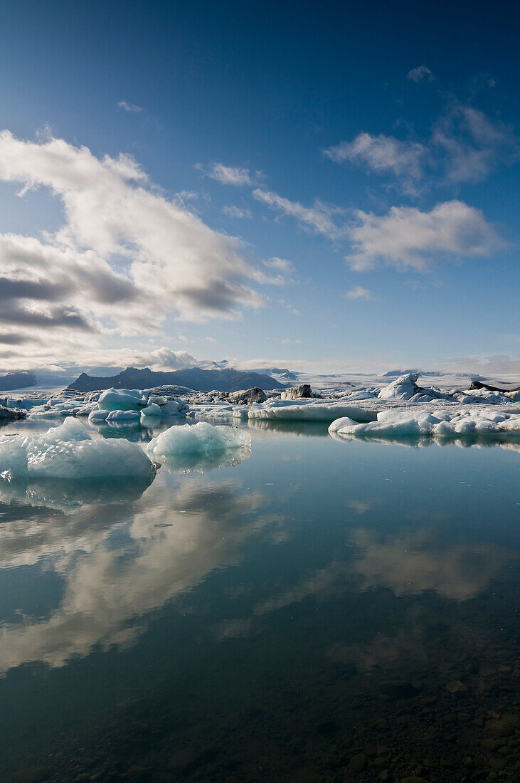 Reflection of the sky in the Jokulsarlon glacier lake, Iceland, Scandinavia, Europe