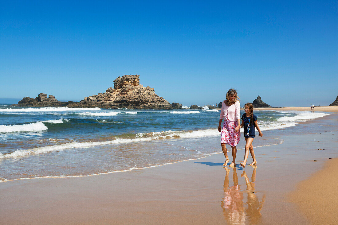 Mother and daughter strolling along the beach Praia da Castelejo, Atlantic Coast, Algarve, Portugal, Europe