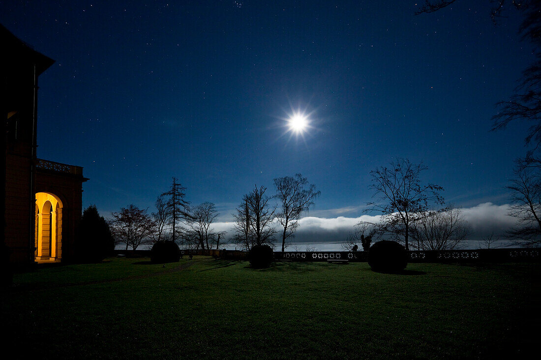 Moon over Lake Starnberg, Castle Unterallmannshausen at dawn, Upper Bavaria, Germany