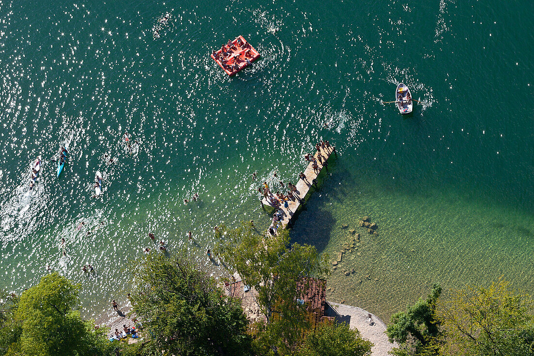 Young people bathing in lake Starnberg with pier, rowing boats and inflatable mattress, aerial view, Bavaria, Germany
