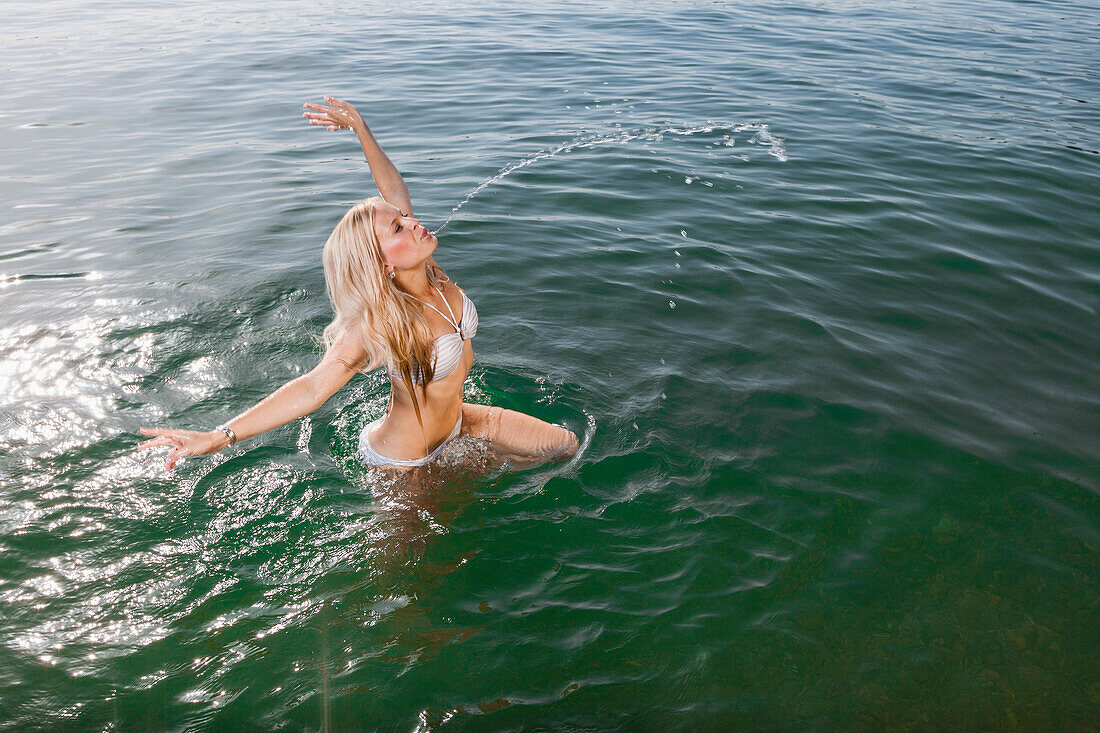 Young woman bathing in Lake Starnberg, Bavaria, Germany