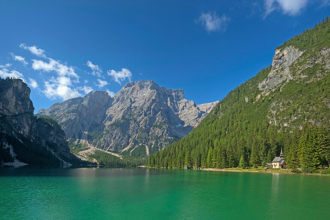 Lake Pragser Wildsee with chapel in the sunlight, Dolomites, South Tyrol, Italy, Europe