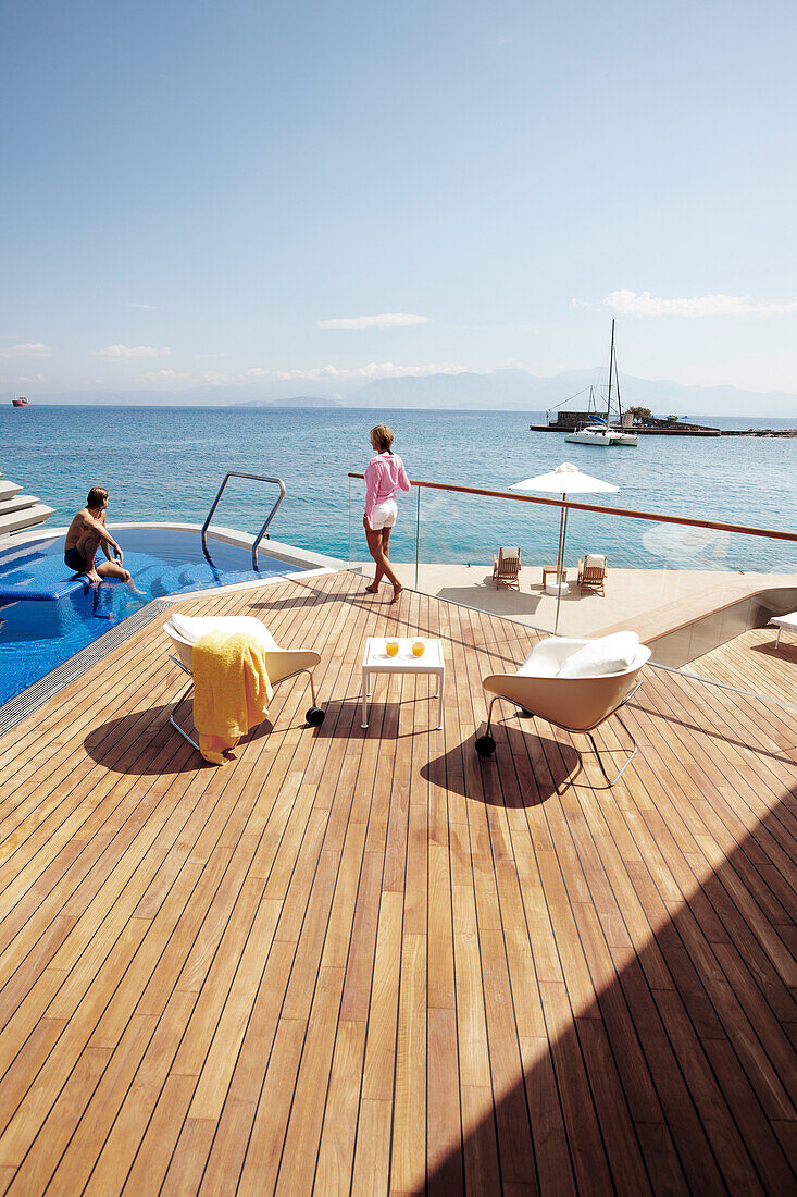 Mann und Frau am Pool und Deck der Yachting Club Villas, Elounda Beach Resort, Elounda, Kreta, Griechenland