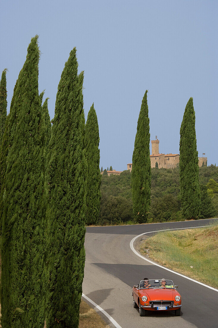 Vintage car on a country road at the Montalcino region, Tuscany, Italy, Europe