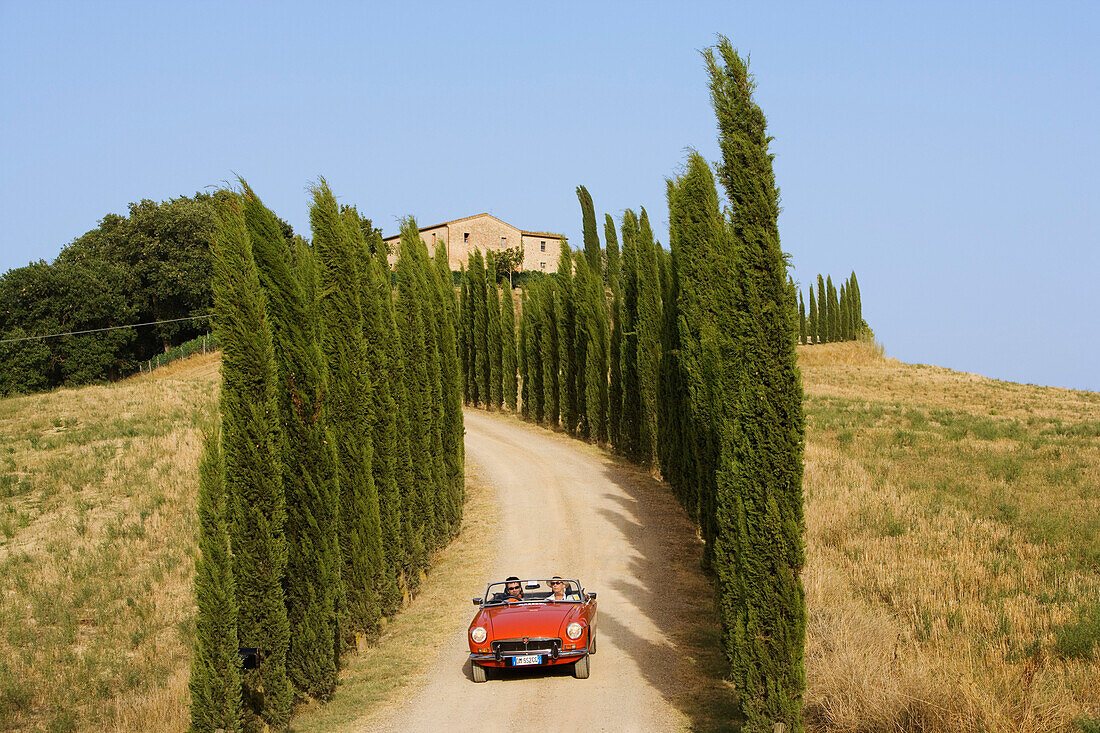 Vintage car on a country road at the Montalcino region, Tuscany, Italy, Europe