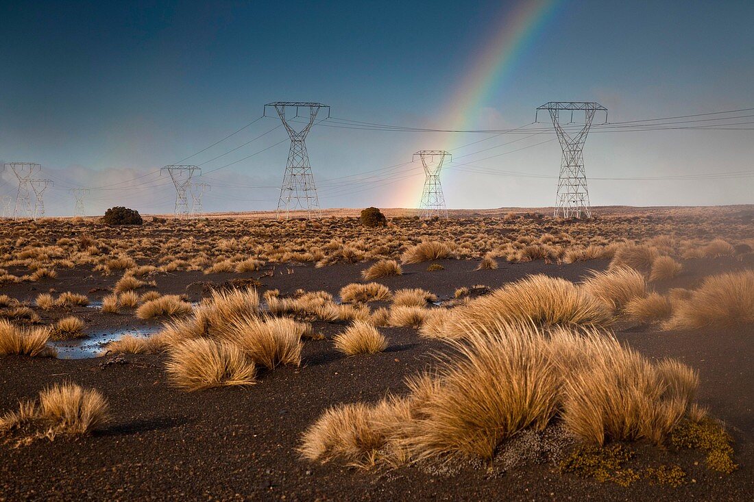 Rainbow over power plyons, Rangipo desert near Mt Ruapehu, Tongariro National Park.