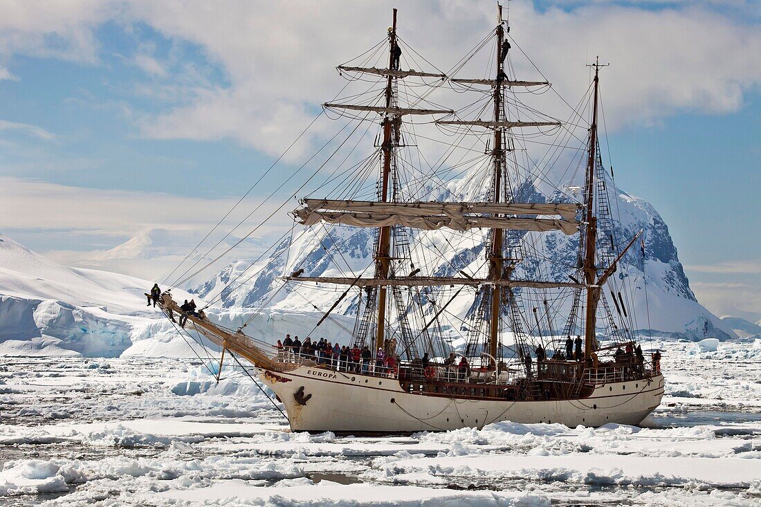 Dutch square rigged tourist ship Europa in heavy pack ice, Penola Strait, Antarctic Peninsula