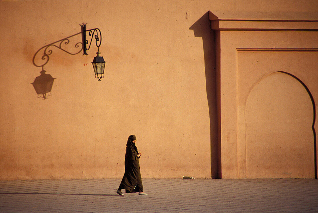 Veiled Woman Walking Along Empty Street, Morocco