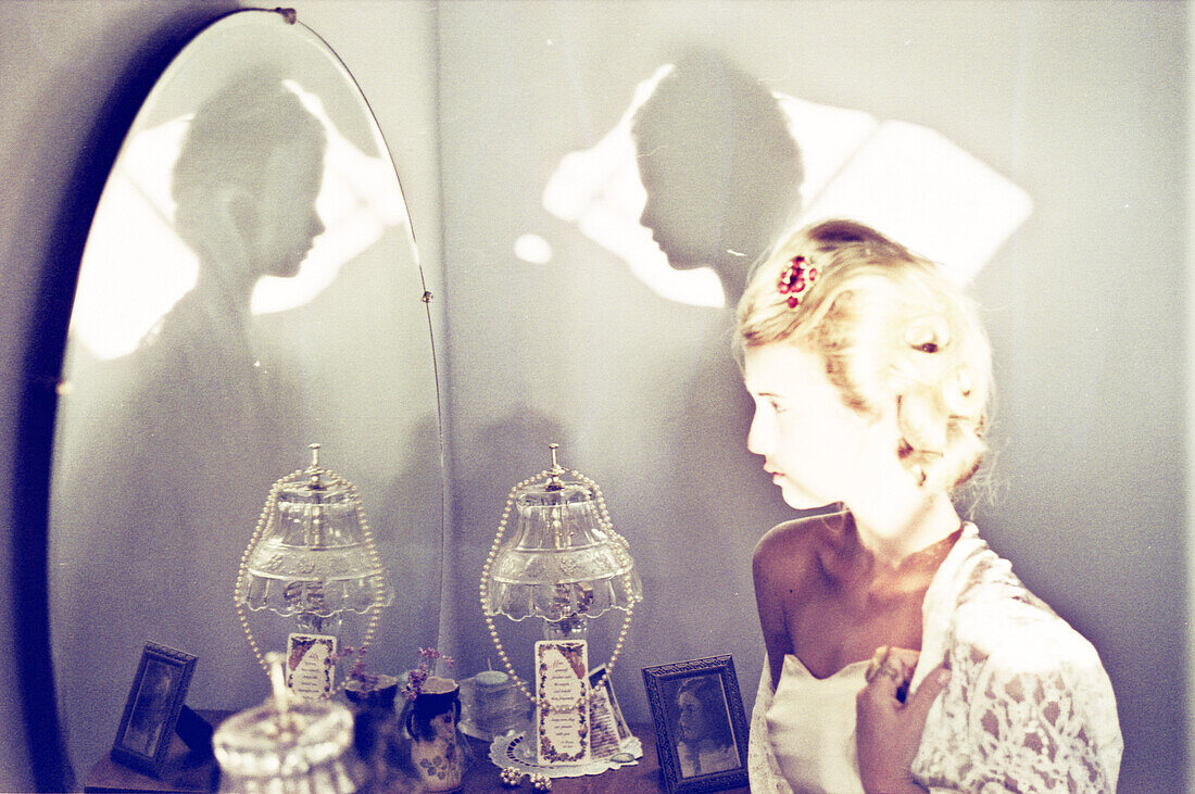 Blonde Woman Looking in Mirror