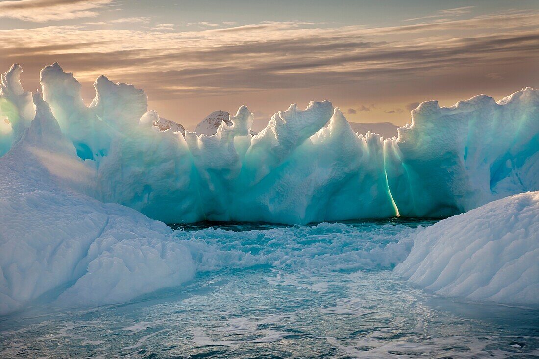 Iceberg backlit by setting sun, Cierva Cove, Antarctic Peninsula.