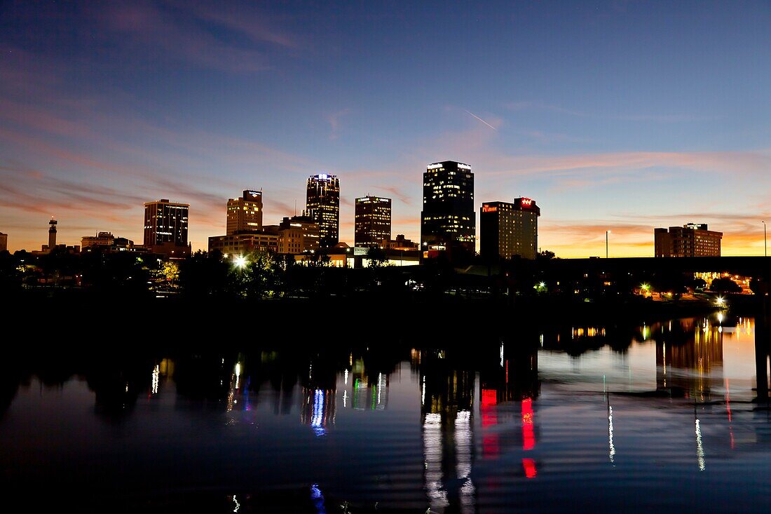 The Arkansas river and the city skyline of Little Rock Arkansas at dusk