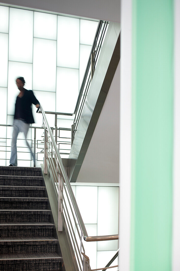 Man on the stairs in a hotel, Brussels, Belgium