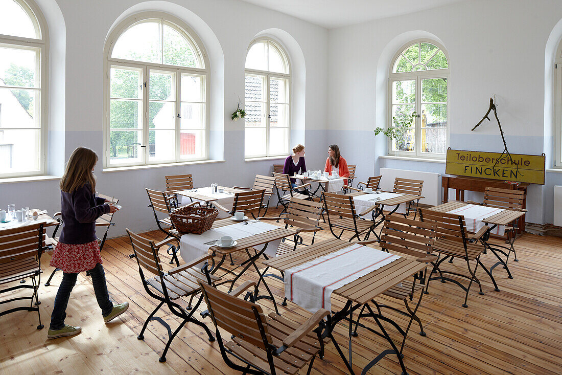 Girl in a hotel breakfast room, Fincken, Mecklenburg-Western Pomerania, Germany