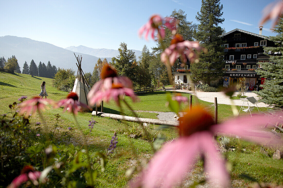 View of the hotel through flowers, Ecohotel Grafenast, Am Hochpillberg, Schwaz, Tyrol, Austria