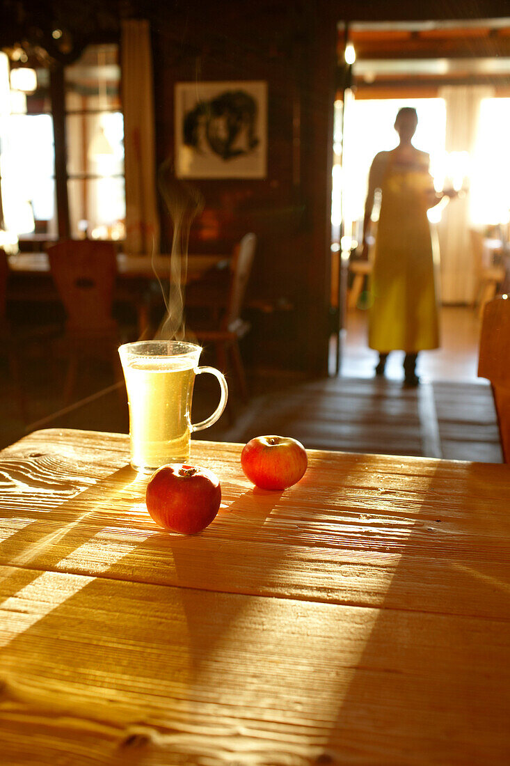 Steaming tea and apples on the table of the Panorama Room, Ecohotel Grafenast, Am Hochpillberg, Schwaz, Tyrol, Austria