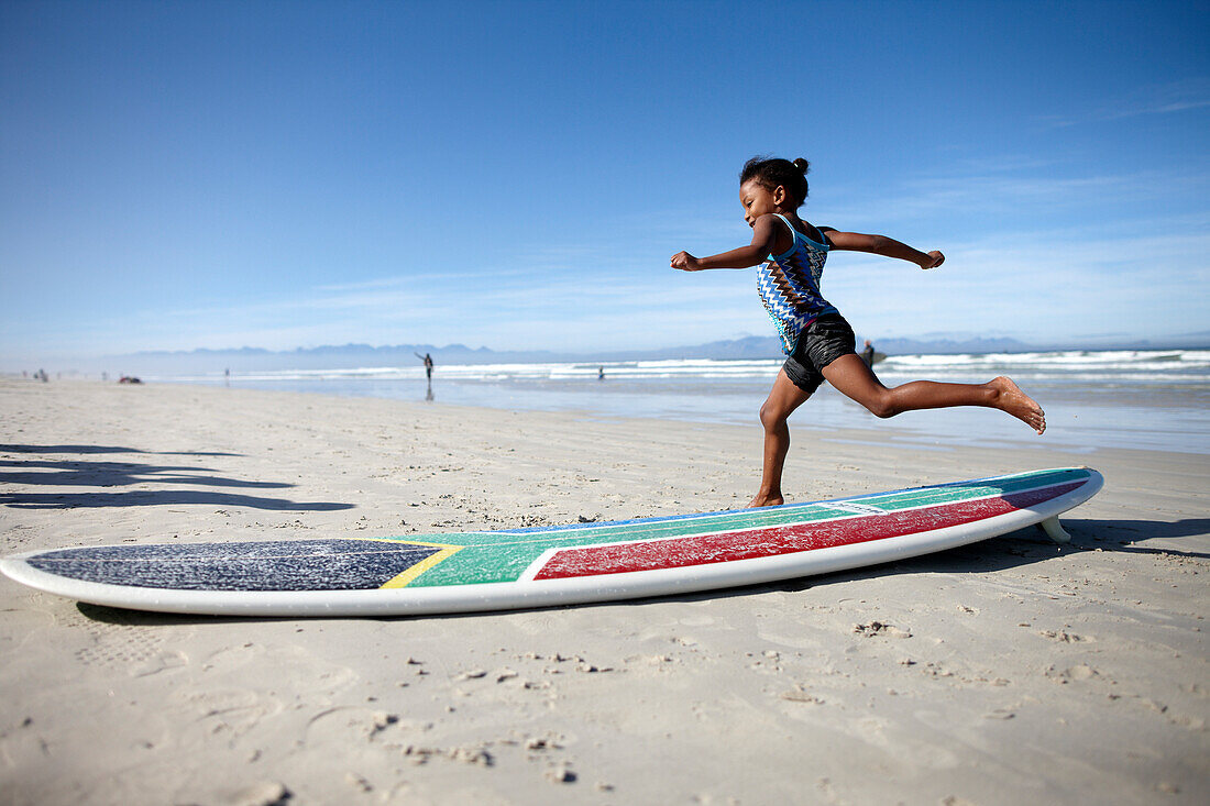 Girl with surfboard on the beach, Muizenberg, Peninsula, Cape Town, South Africa, Africa