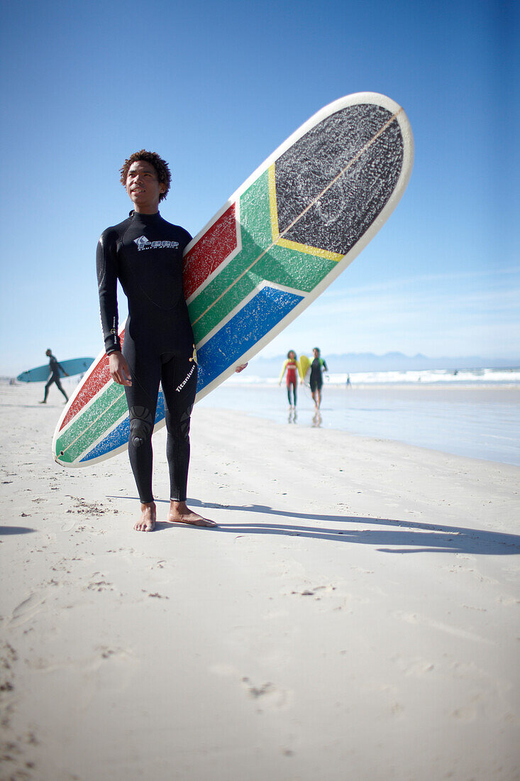 Surfer Alfonso Peters on the beach, Muizenberg, Peninsula, Cape Town, South Africa, Africa