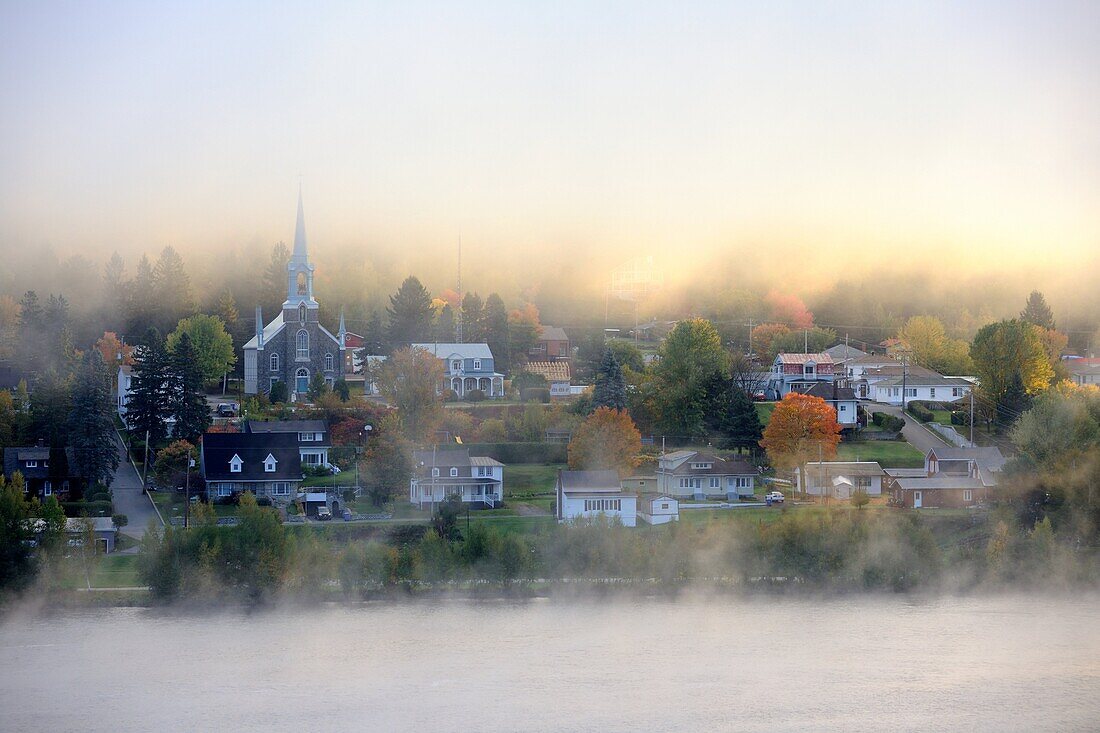 Early morning mist and autumn coloured in Grande Piles Village and St Maurice river  Quebec, Canada