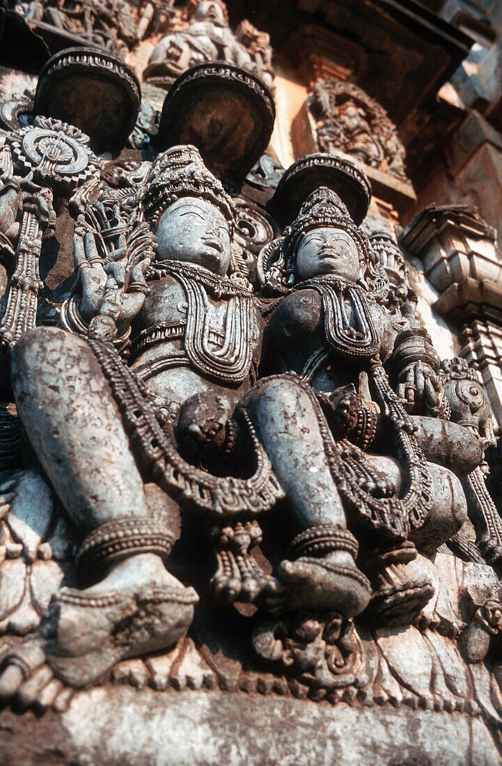 Carved in stone figures of Shiva and Parvati in Hindu temples of Halebid