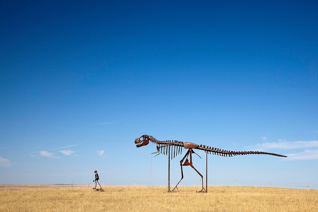 Stamford, South Dakota - Skeletons of a man and a dinosaur walking across the plains of South Dakota