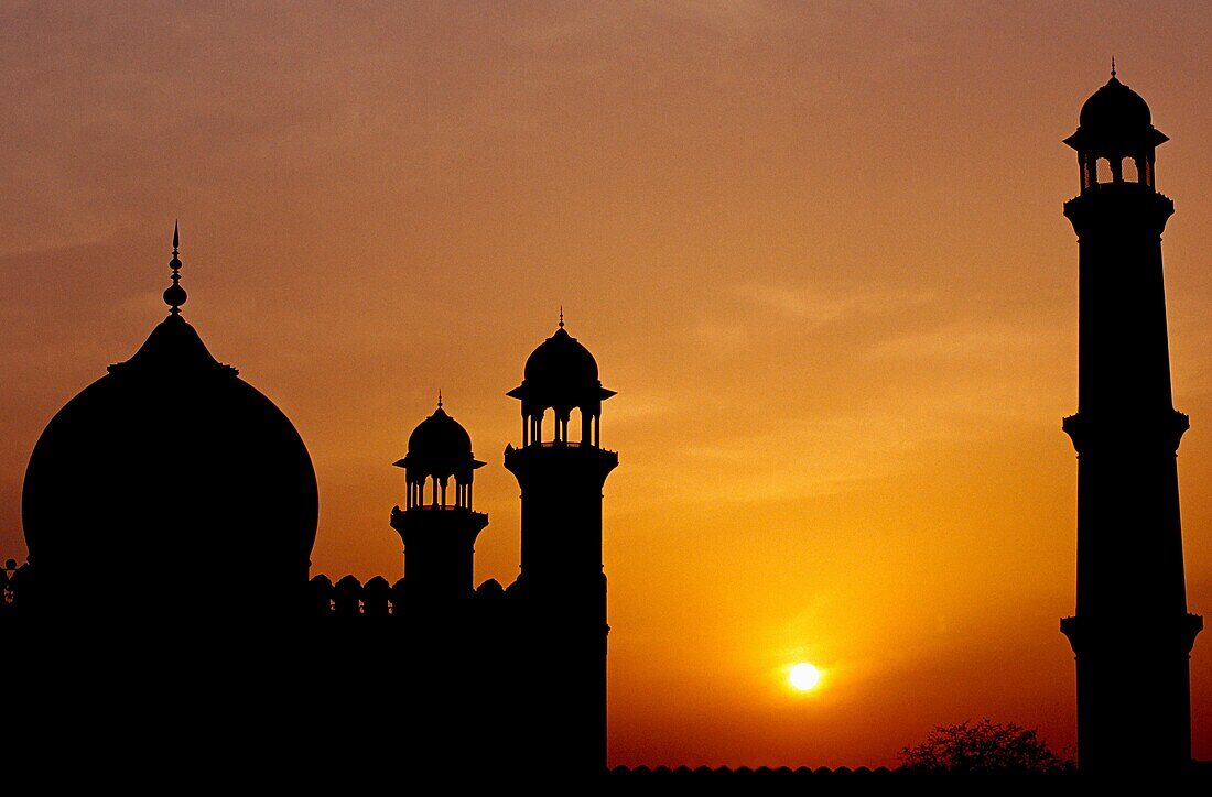 At sunset, a silhouette of the Badshahi Mosque in Lahore Pakistan