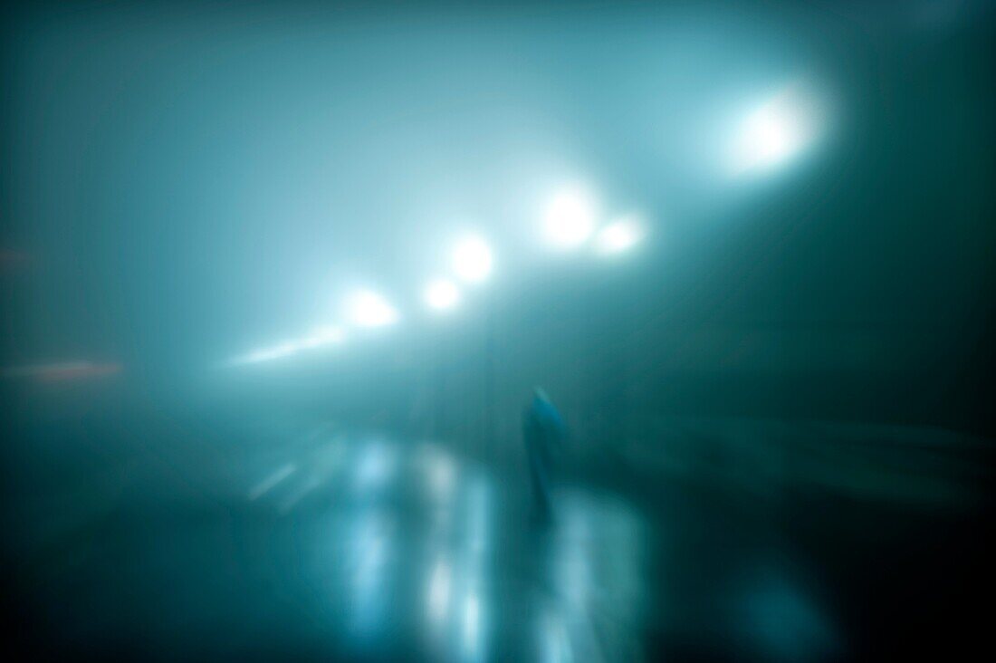 Figure walking on a wet foggy night