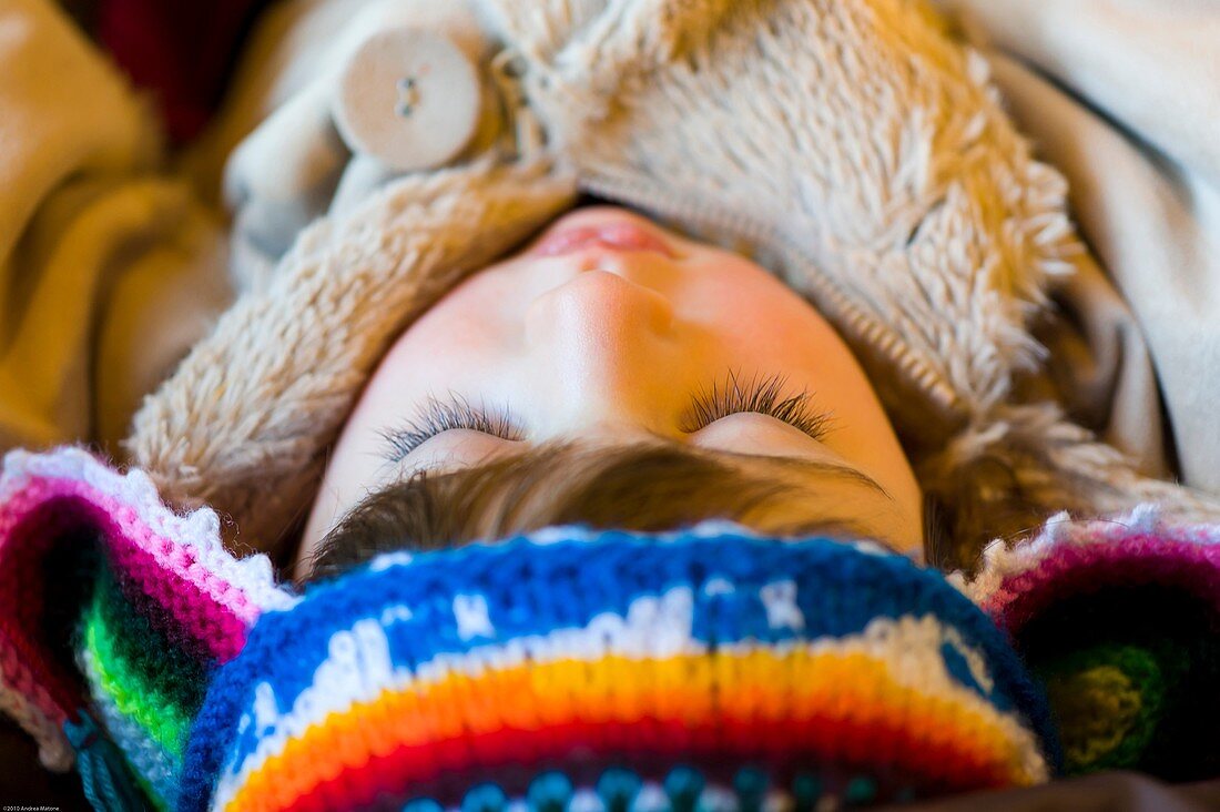 Female baby child with a colorful winter hat