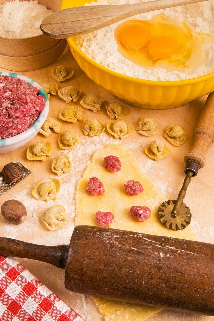 Homemade Tortellini, ring-shaped pasta  They are typically stuffed with a mix of meat pork loin, prosciutto and cheese, Italian gastronomy, Italy