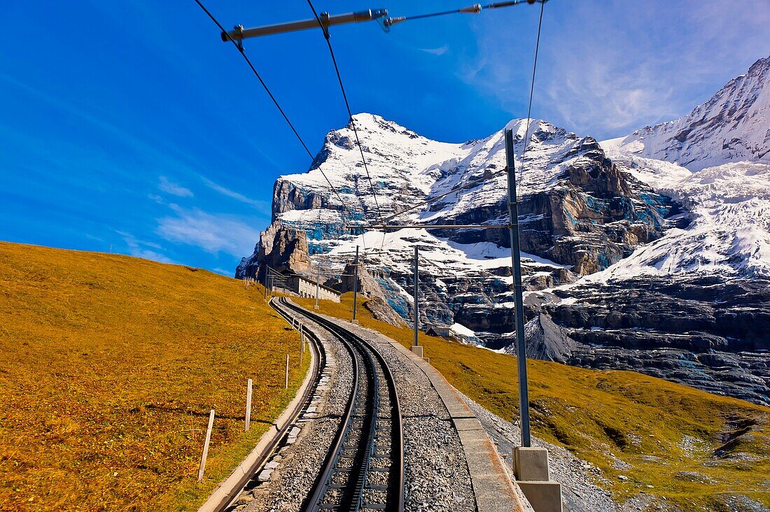 Jungfrau Railway train climbing from Kleine Scheidegg to Eigergletscher, Swiss Alps, Canton Bern, Switzerland