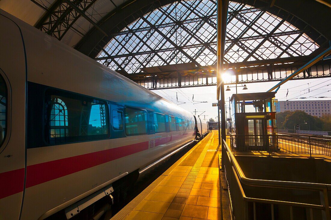 Passengers arrive at the train station at Dresden after sunrise, Saxony, Germany