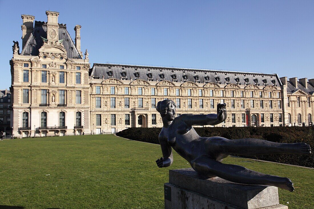 Statue by Aristide Maillol in Jardin des Tuileries with Musee Les Arts Decoratifs in the background. Paris. Ile-de-France. France