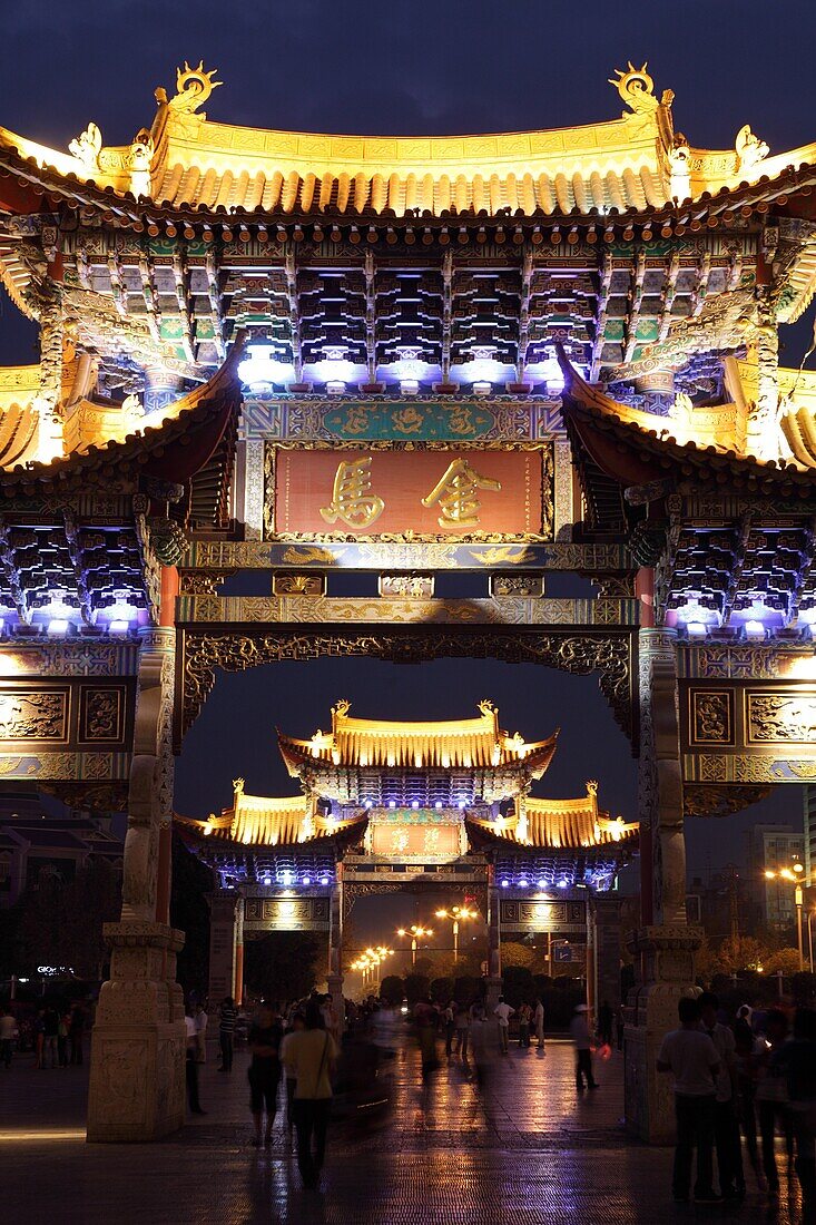 The night view of memorial arches of the Golden Horse and Jade Rooster in Jinmabiji Square  Kunming  China