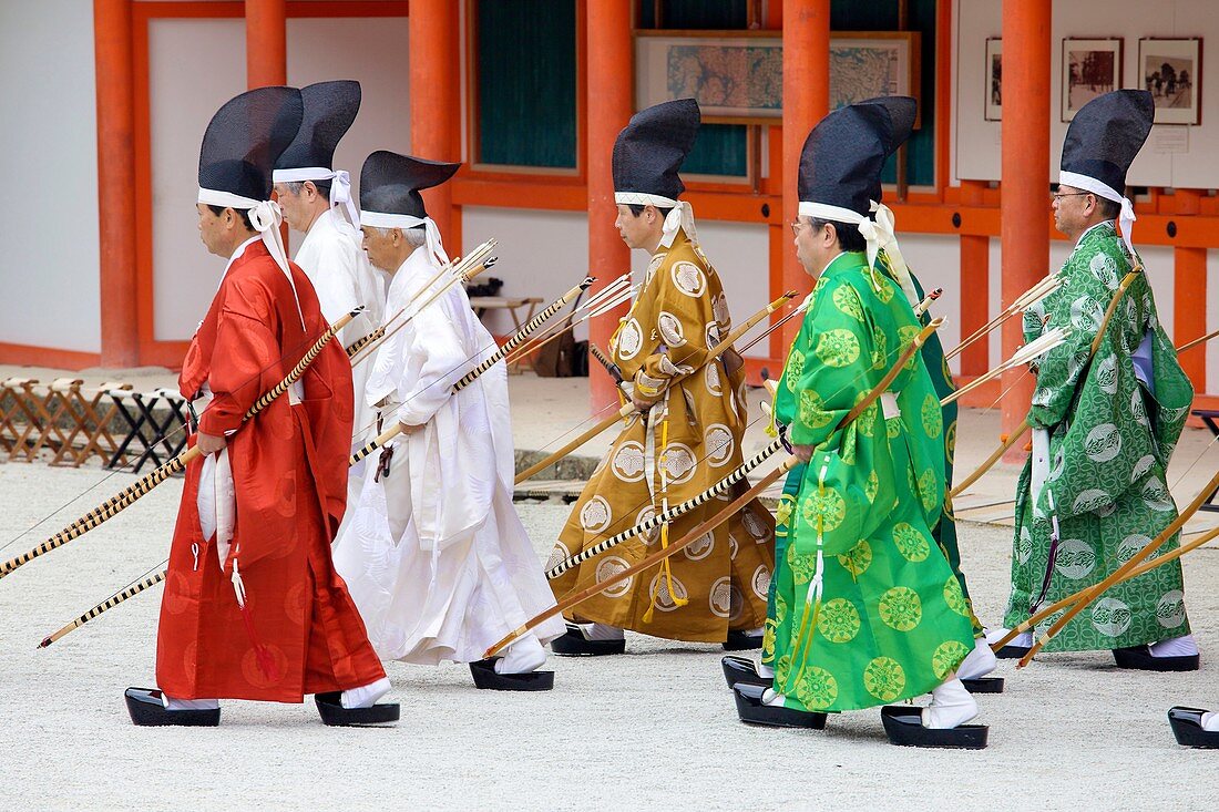Costumed archers participating in Busha Shinji to ward off evil spirits before the festival with Shimogamo shrine in the background