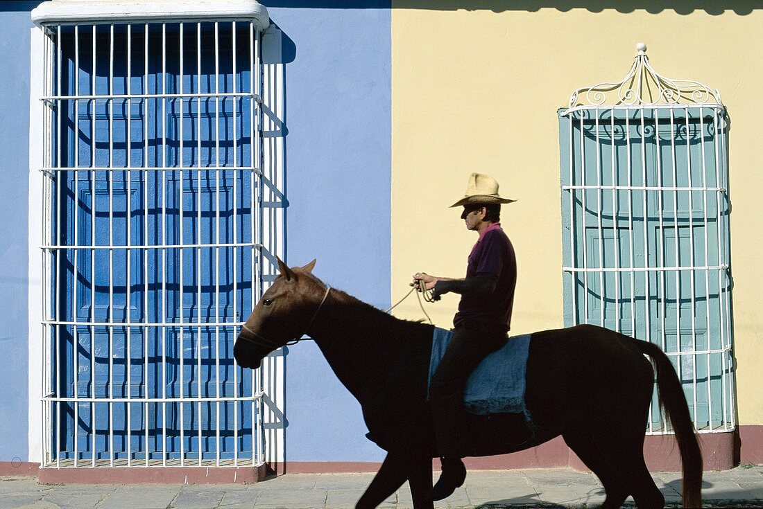 Colonial Grille Windows, Cuba, Horse, Man, Riding, . Colonial, Cuba, Grille, Heritage, Holiday, Horse, Landmark, Man, Riding, Street scene, Tourism, Travel, Trinidad, Unesco, Vacati