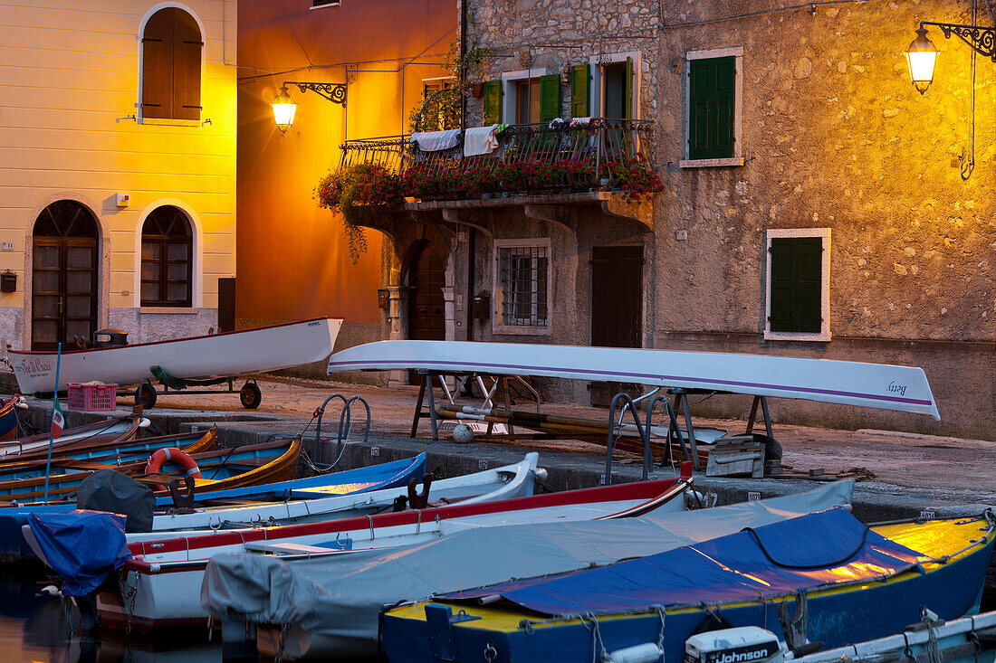 Boats in Cassone harbour in the evening light, Lake Garda, Malcesine, Veneto, Italy