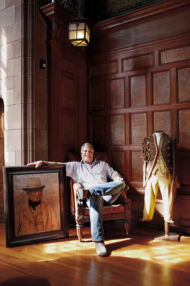 Francis Watson-Armstrong, owner of Bamburgh Castle, with portrait of Lord Armstrong an industrialist who first bought and rebuilt the castle, Bamburgh, Northumberland, England, Great Britain, Europe